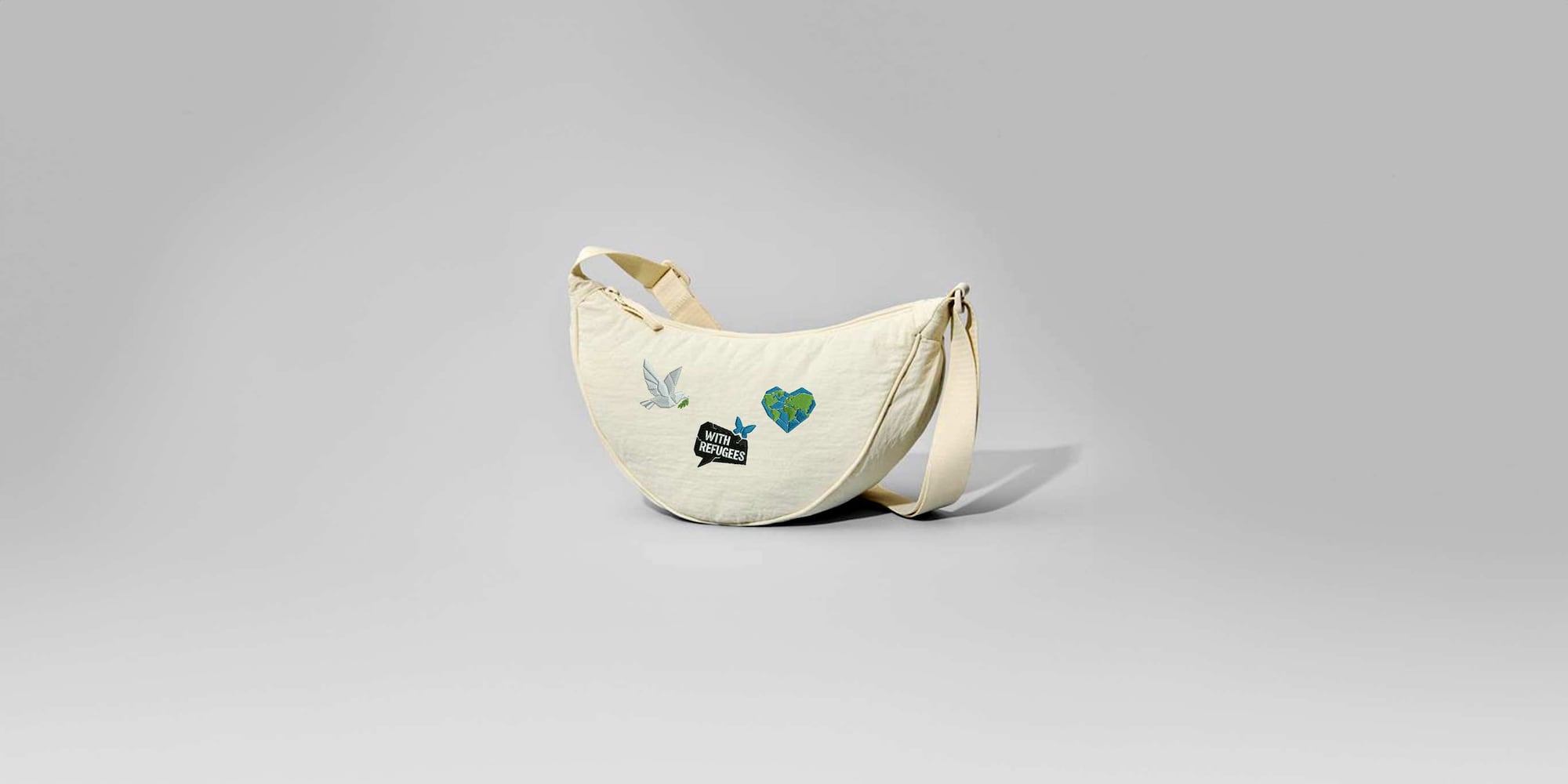 round mini shoulder bag featuring World Refugee Day embroidery