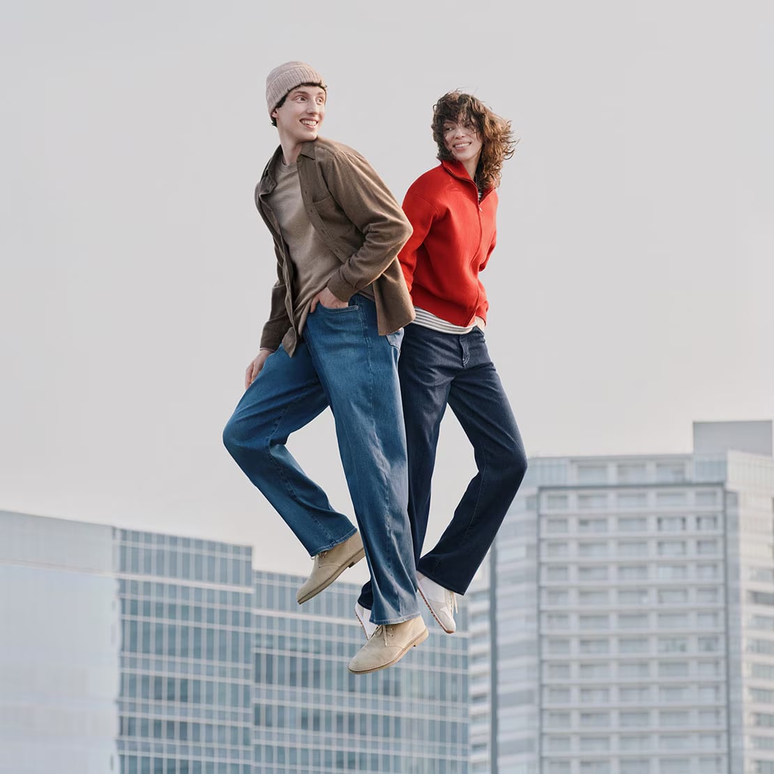 models wearing different styles of uniqlo jeans while packing suitcases into the boot of an off white estate car