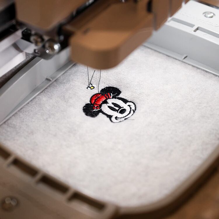 Embroidery machine creating a palm tree