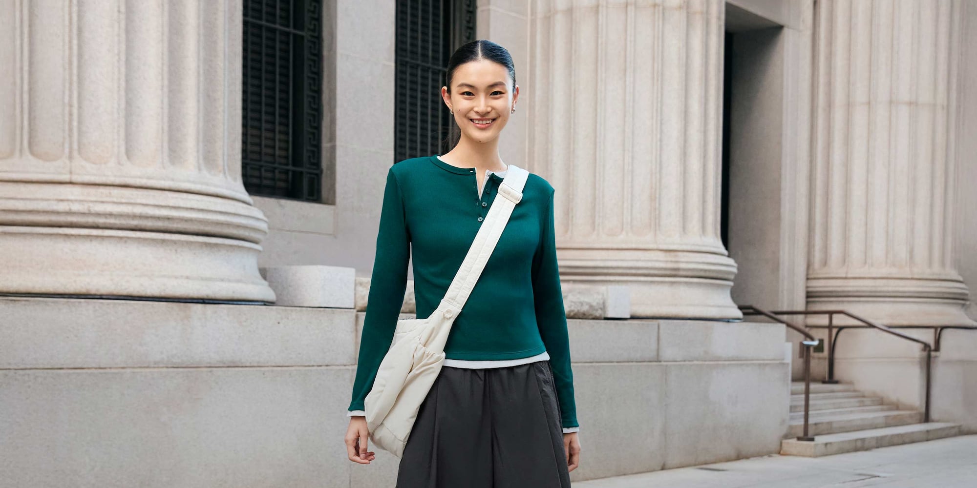 model wearing Ribbed Henley Neck T-Shirt in dark green layered over another Ribbed Henley Neck T-Shirt with dark grey culottes