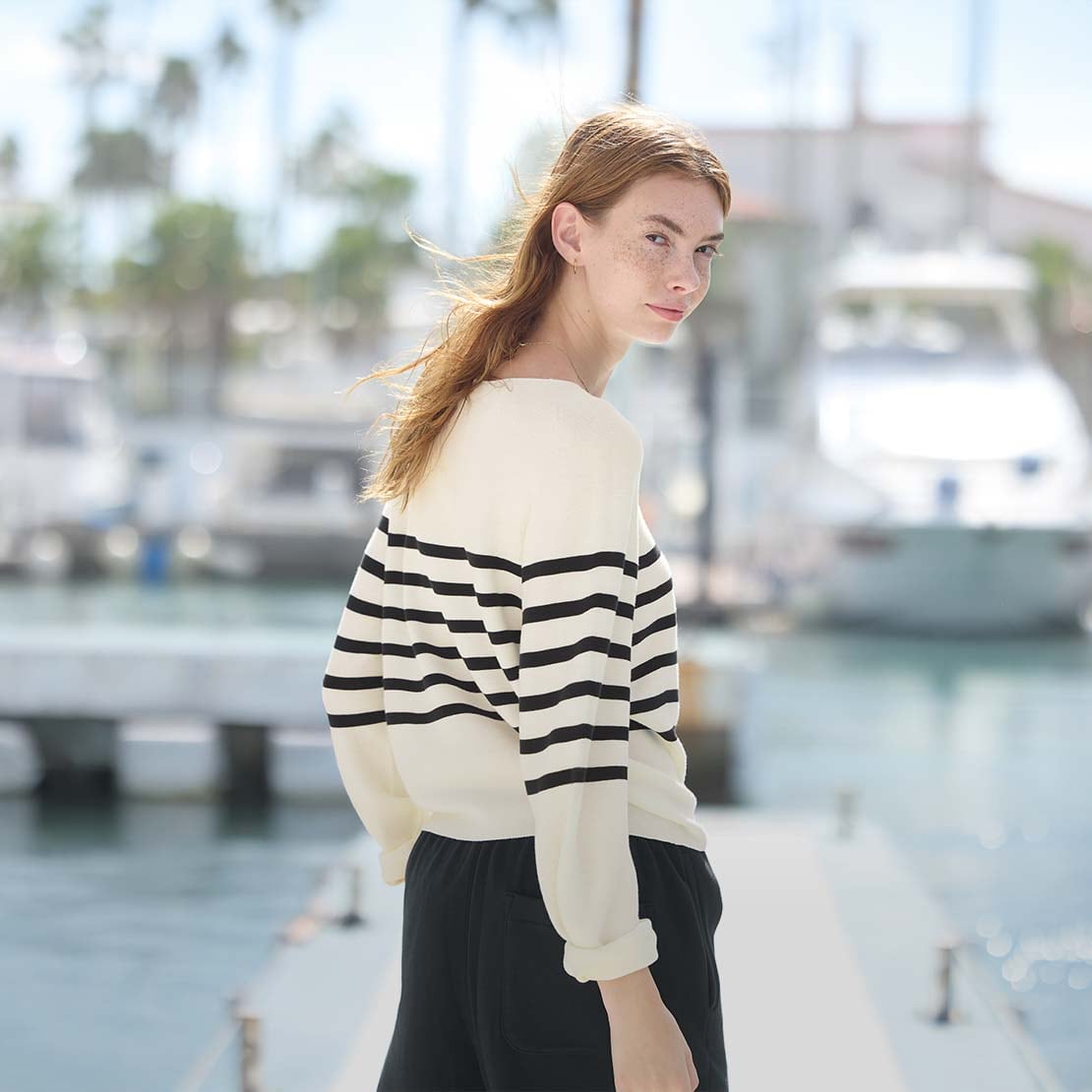 model wearing 3D Knit Seamless Cotton Crew Neck Volume Sleeve Jumper in off white with a navy stripe