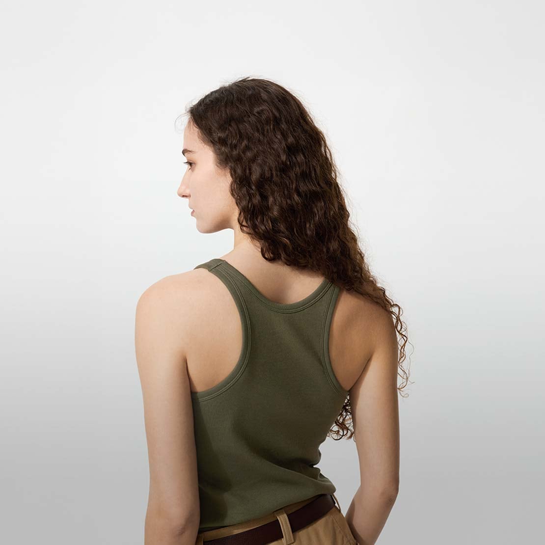 model wearing Racer Back Bra Top in olive with tan trousers