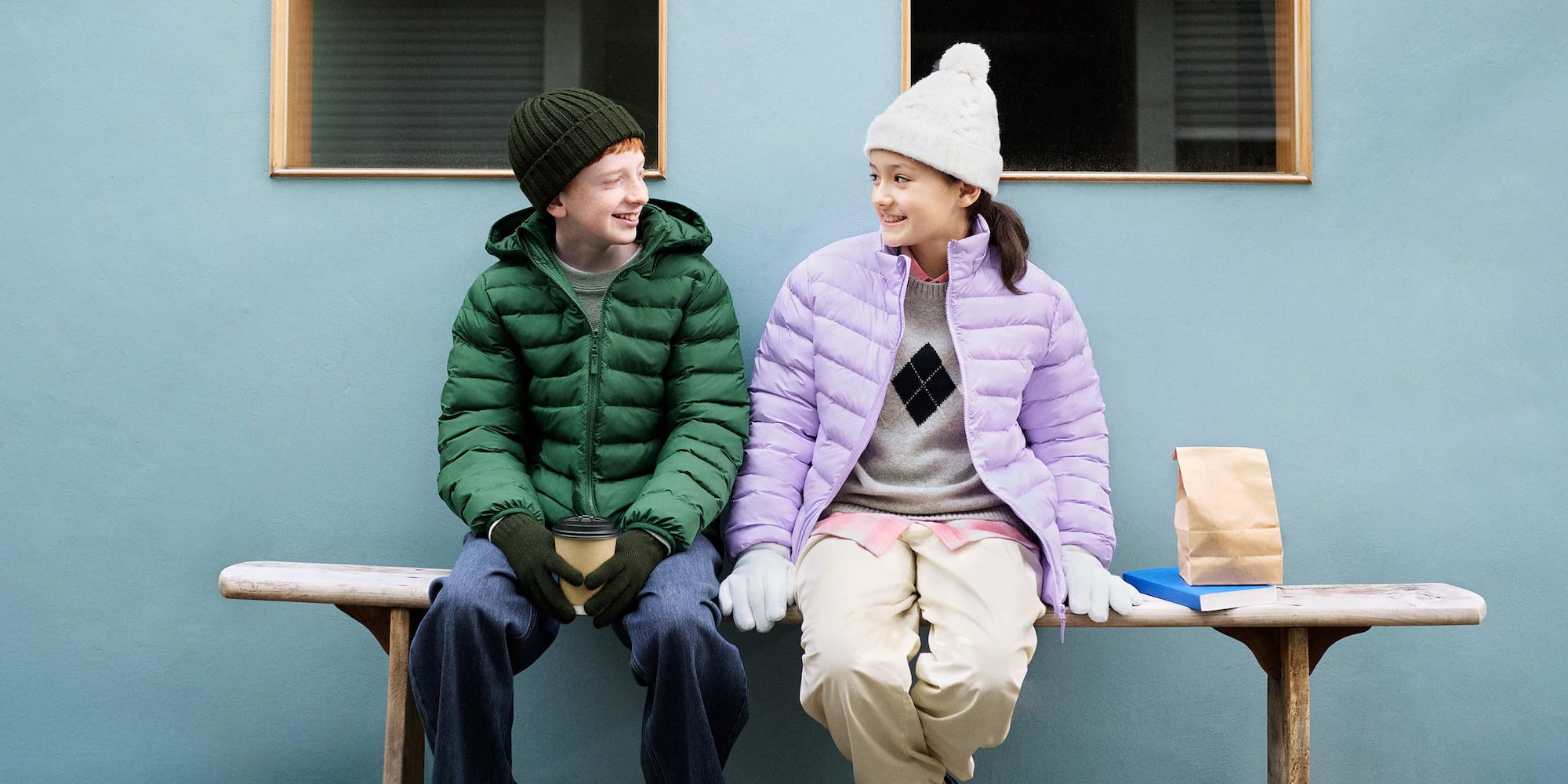 two models wearing PUFFERTECH jackets in green and light blue while running around outside