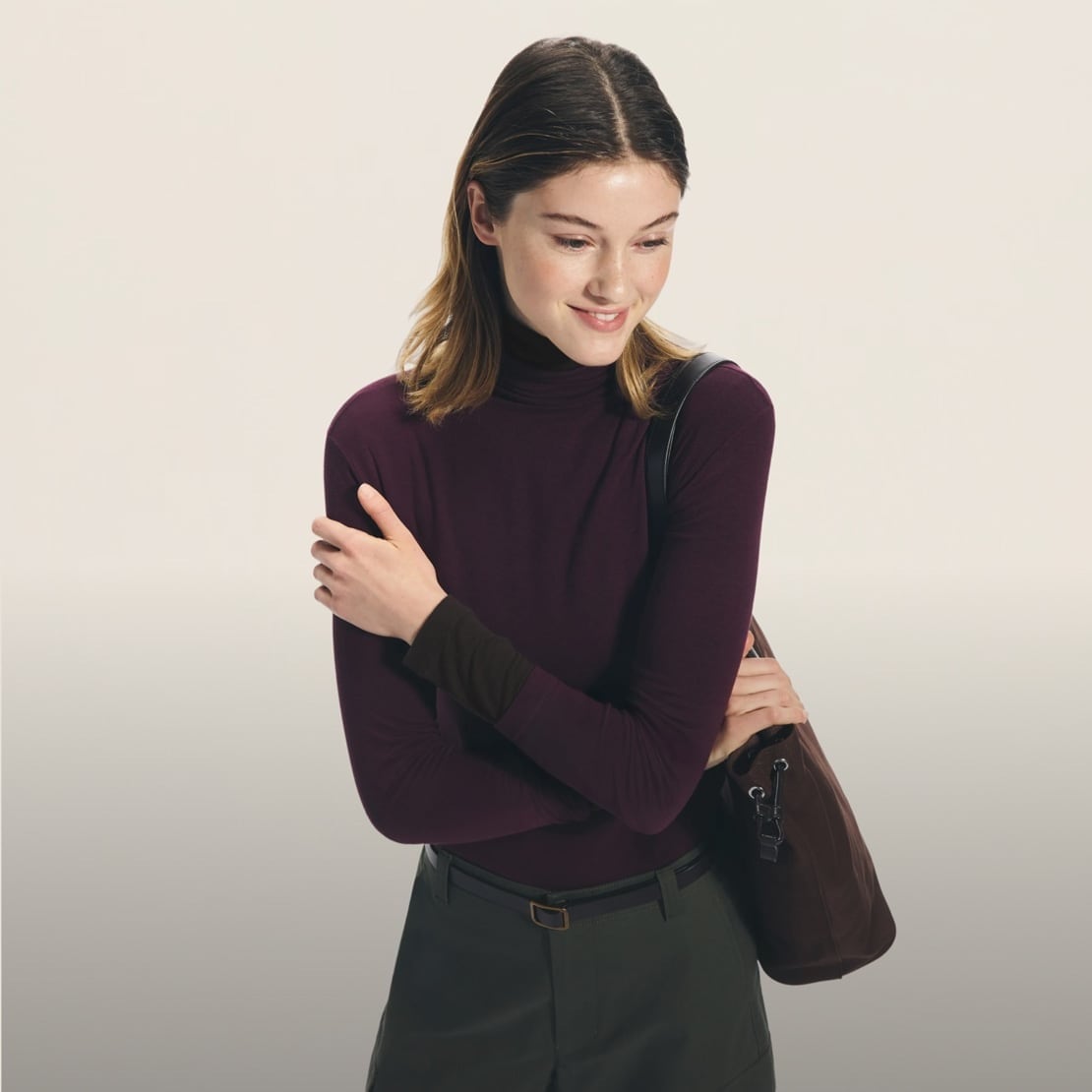 model wearing HEATTECH Extra Warm Cashmere Blend* Turtle Neck in wine with green trousers