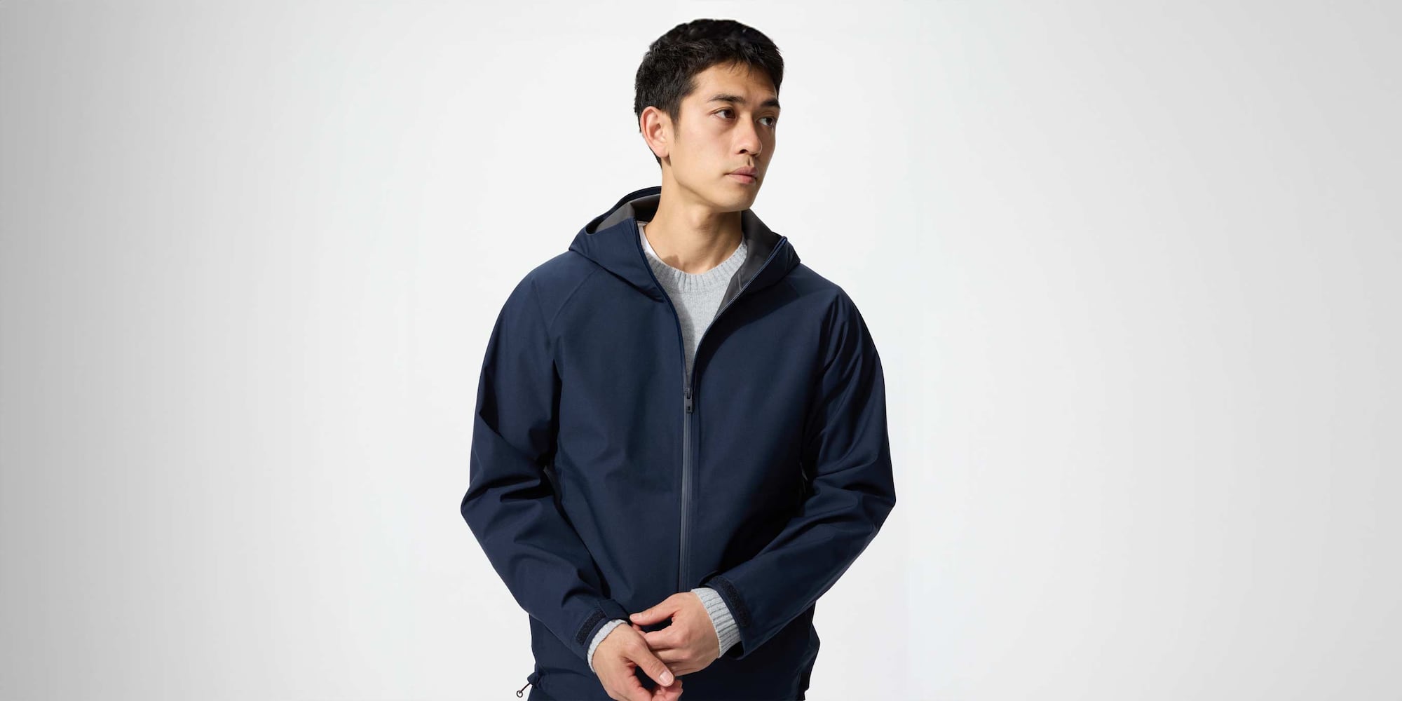 model wearing BLOCKTECH Parka in navy over a grey knit