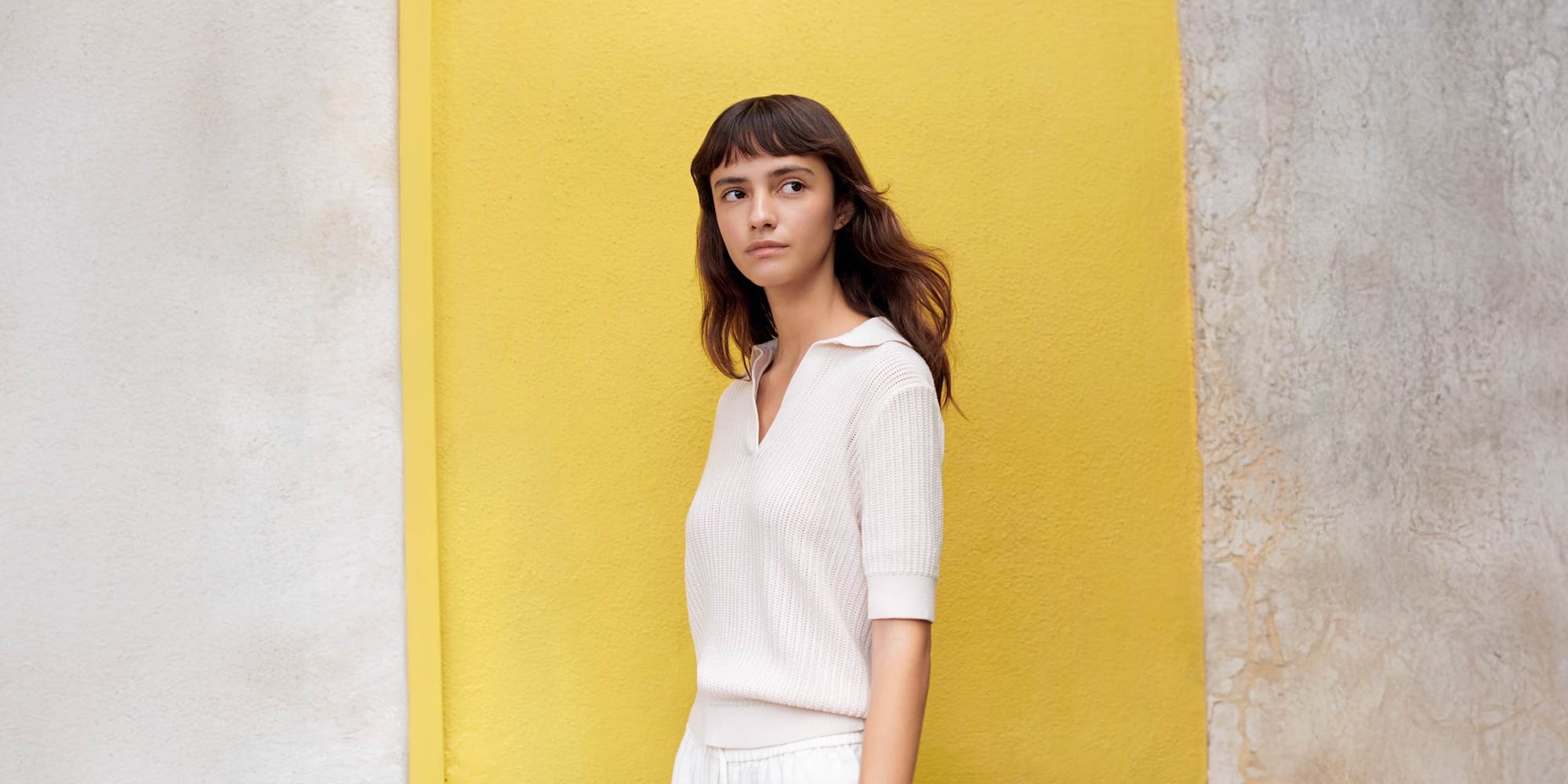 model wearing off white short sleeve knit with skipper collar