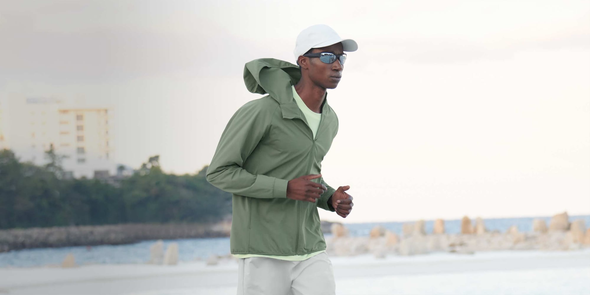 model wearing DRY-EX UV Protection Full-Zip Hoodie in olive while running outside