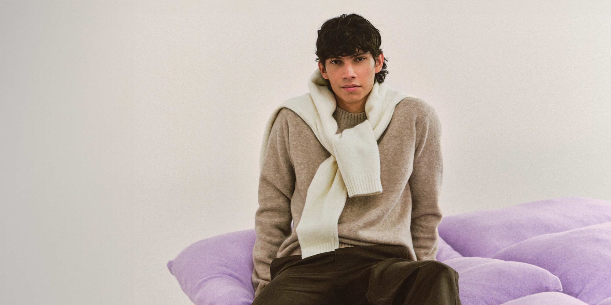 model wearing Soufflé Yarn Crew Neck Jumper in beige with another in off white draped around the shoulders