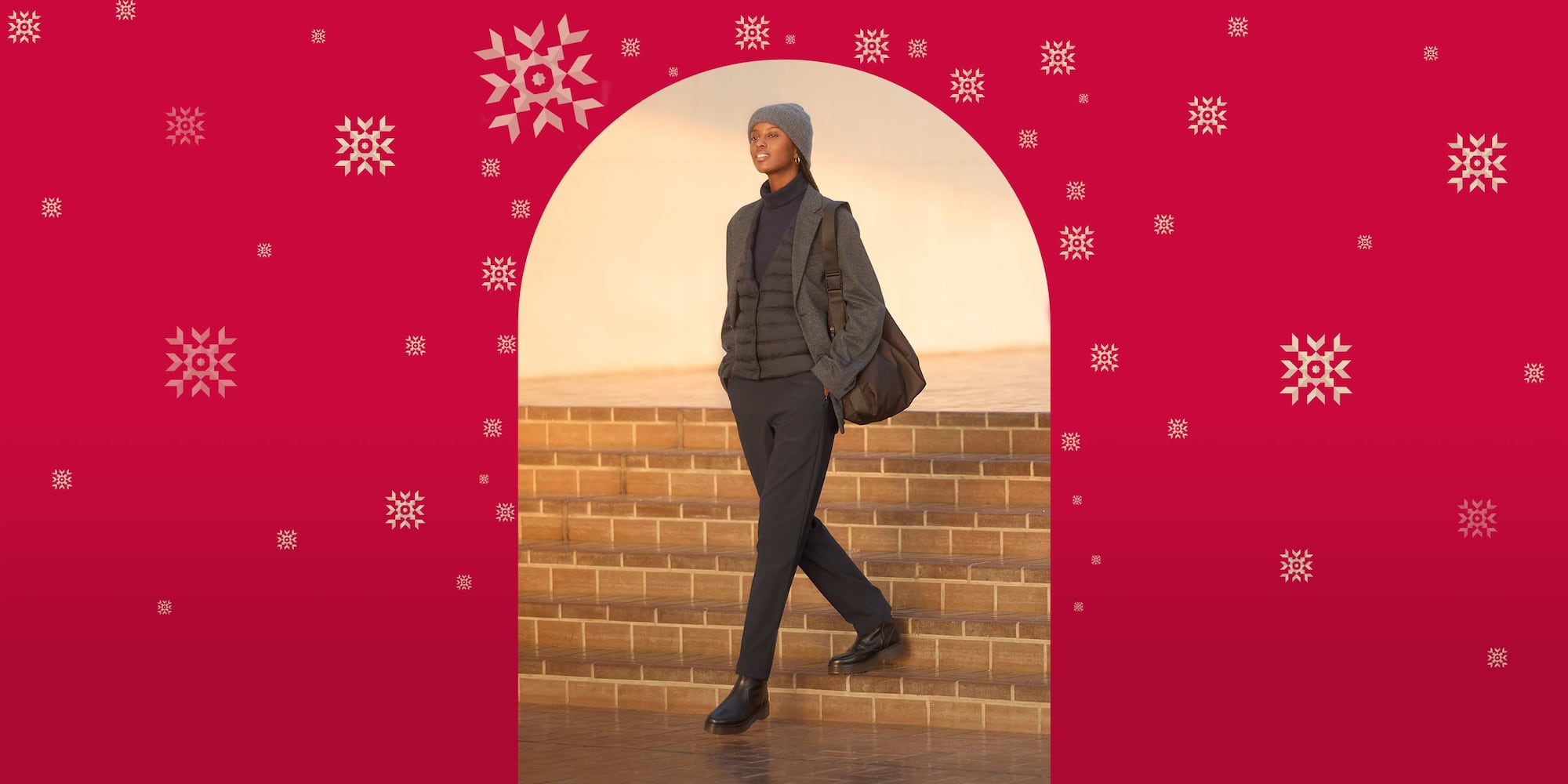 model wearing Warm Stretch Trousers in dark grey with a dark grey turtleneck, quilted jacket, blazer and beanie