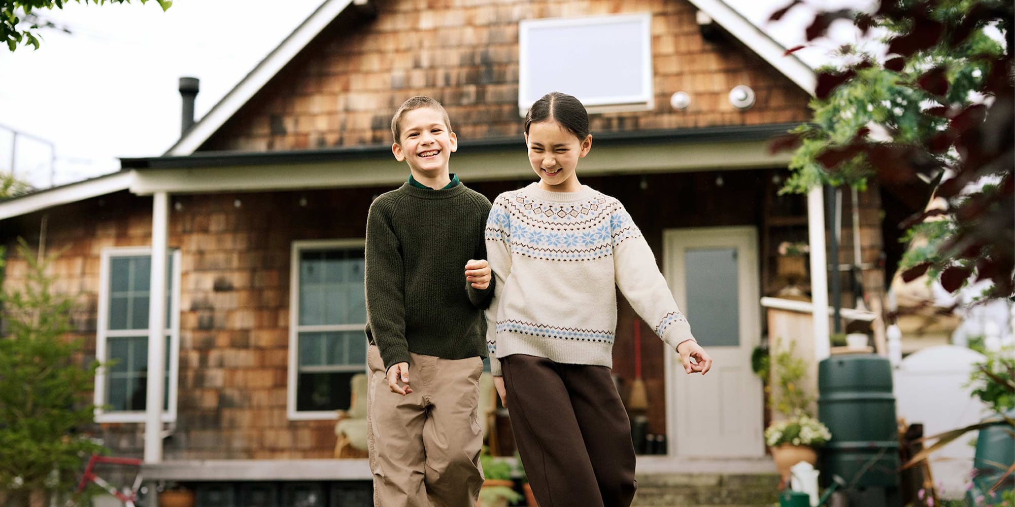 two models wearing Soufflé Yarn Jumpers, one dark green, one beige with a fair isle knit