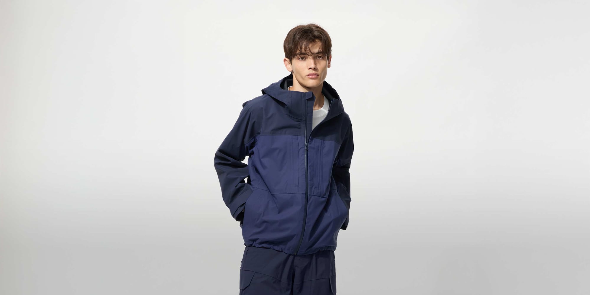 model wearing BLOCKTECH Parka in a navy colour block design