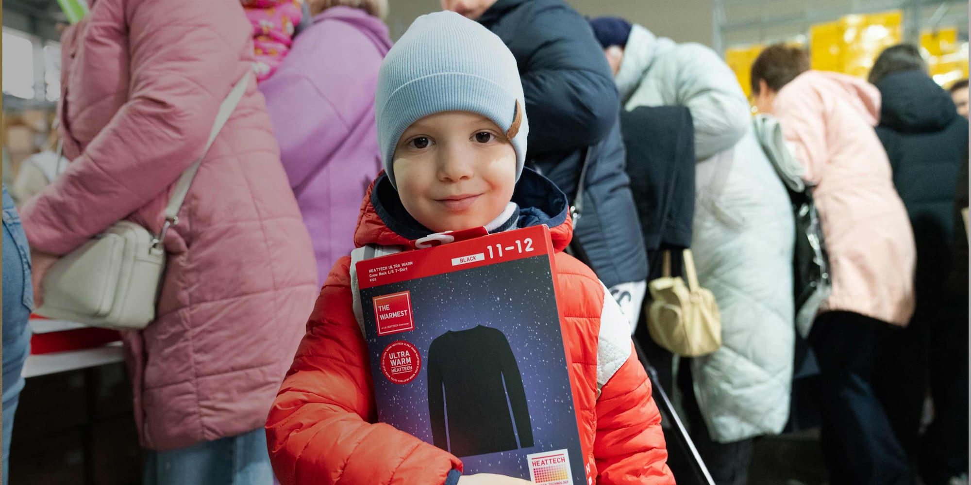 child holding UNIQLO HEATTECH Ultra Warm base layer