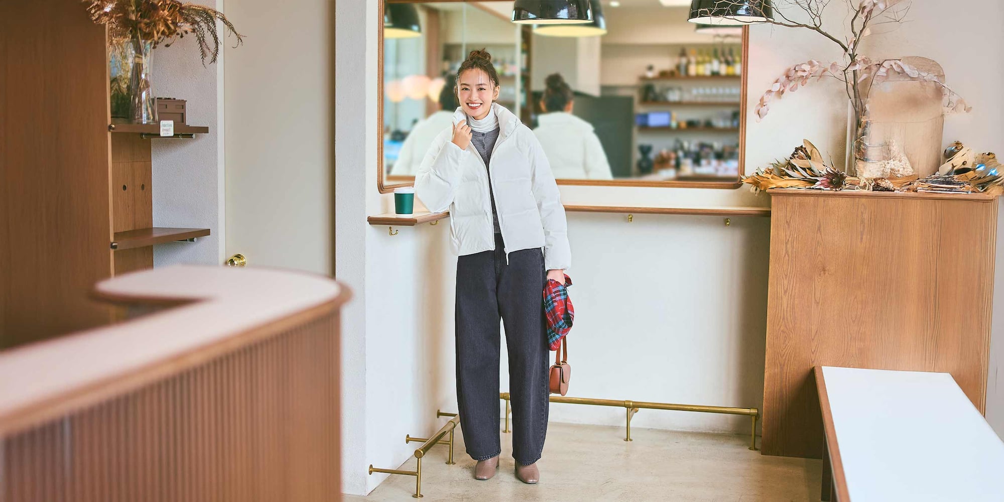model wearing Baggy Curve Jeans in black with a layered grey top, white turtleneck and white Seamless Down Short Jacket