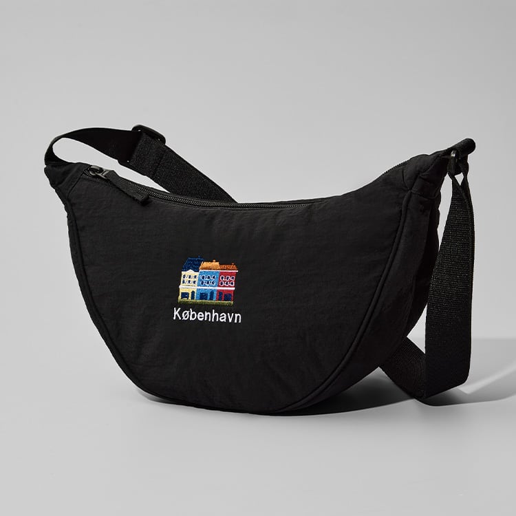 black round mini shoulder bag with embroidery of Nyhavn colourful houses and the word København in white