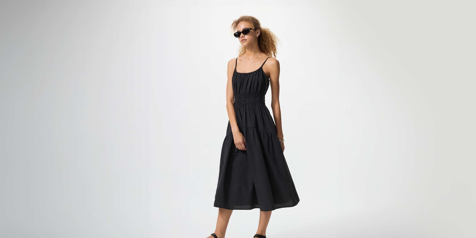model wearing Linen Blend Camisole Dress in black, with black sunglasses