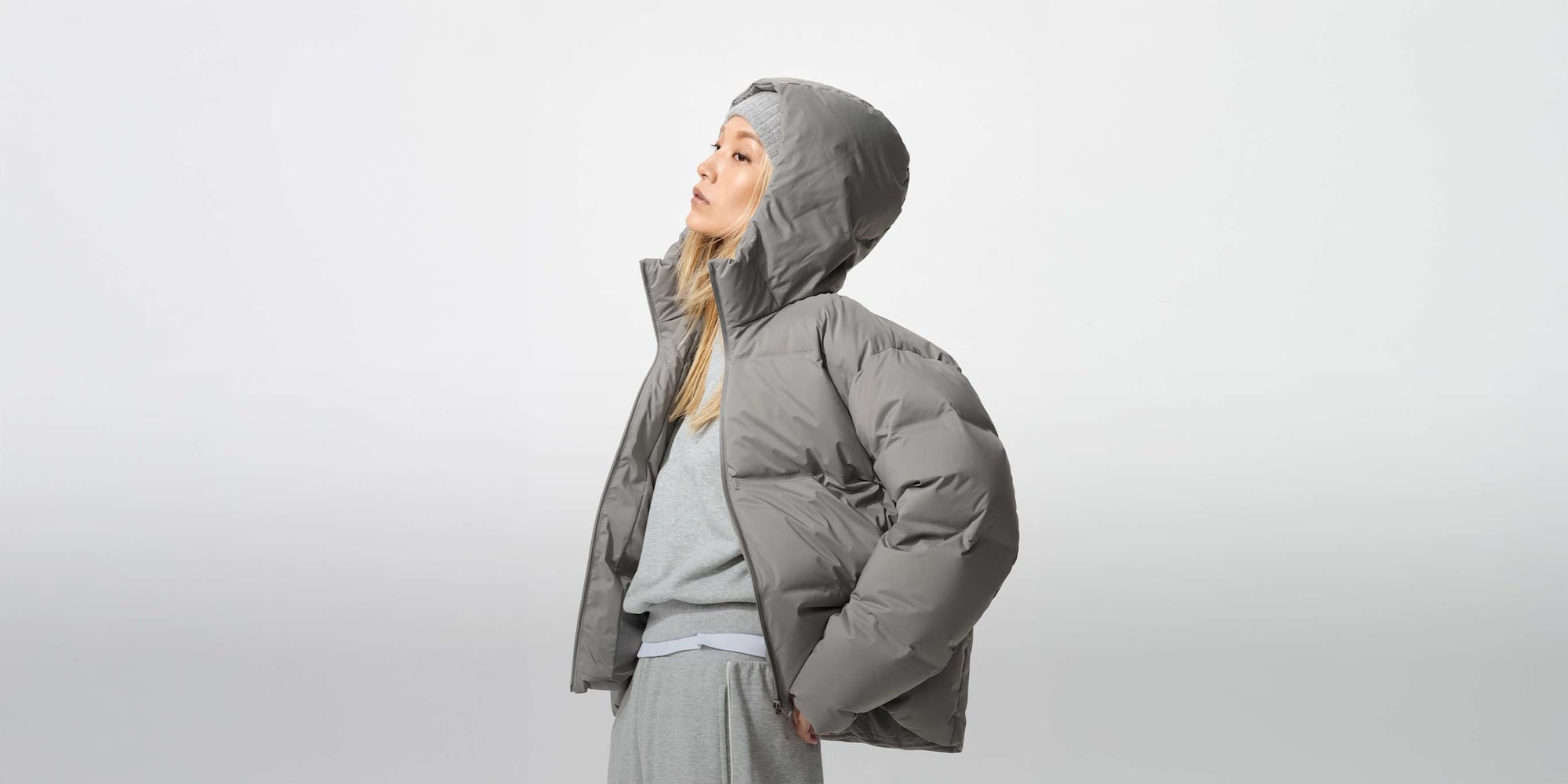 model wearing a grey Seamless Down Parka, with a grey Sweatshirt