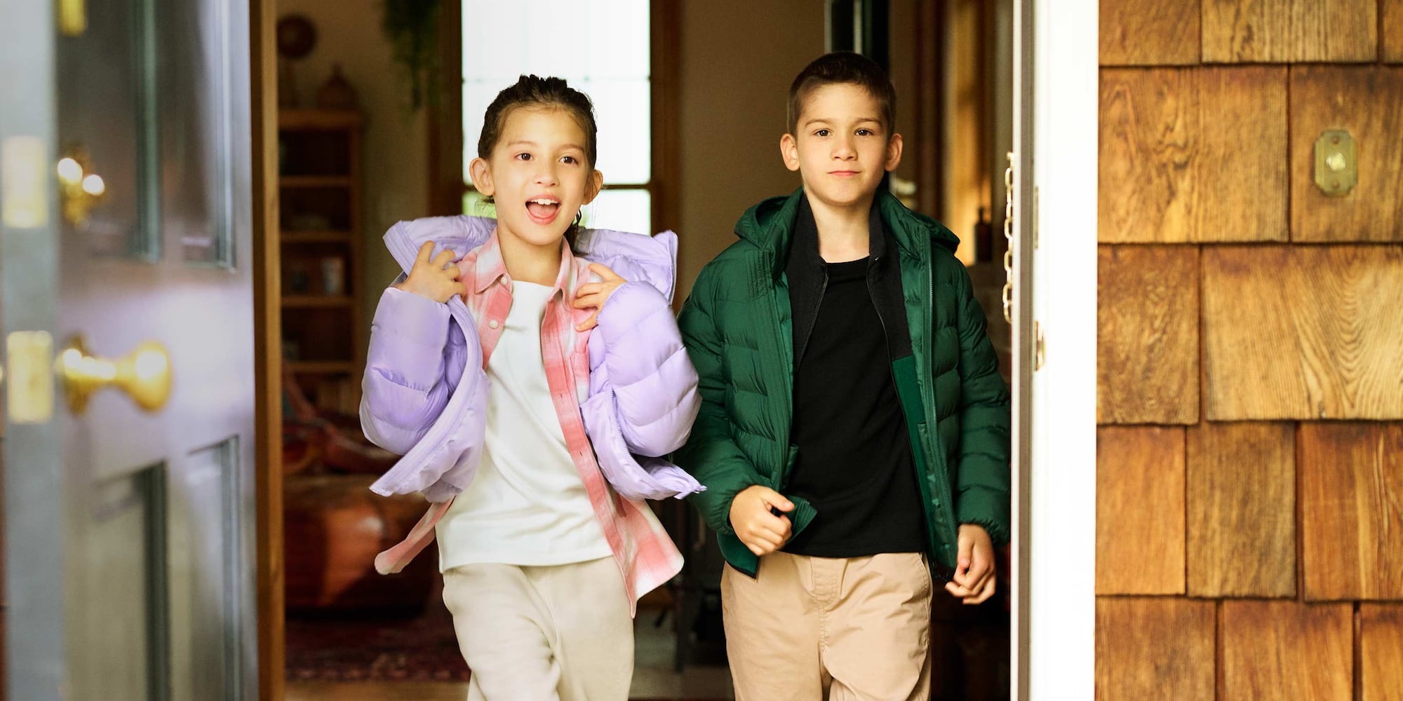 two models wearing HEATTECH Ultra Warm Crew Neck T-Shirts under quilted jackets