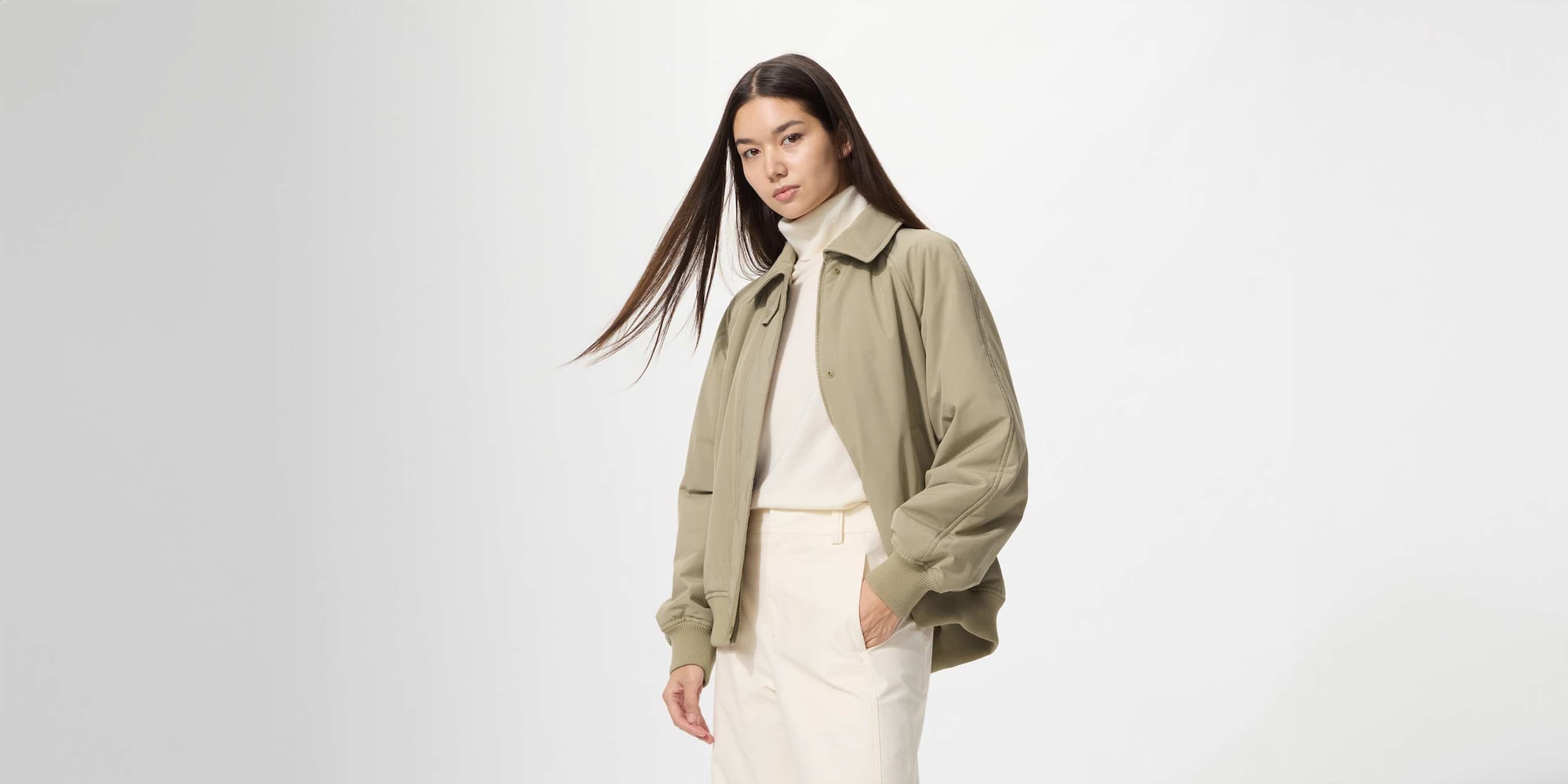 model wearing PUFFERTECH Blouson in beige over an off white turtleneck and trousers